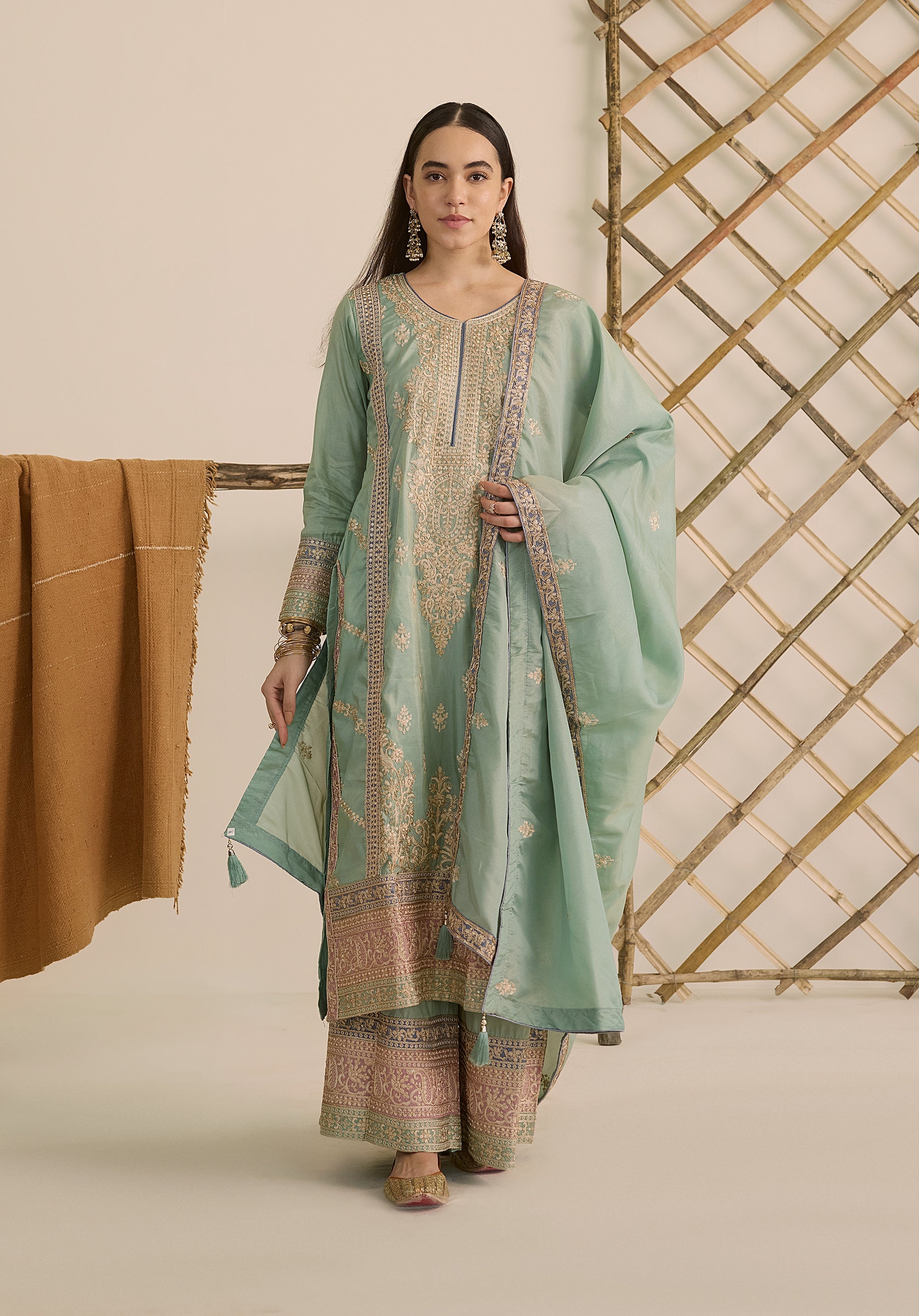 Mint green Vaidehi suit Indian ethnic wear: premium silk with gold floral zardozi embroidery, ornate printed palazzo, graceful dupatta, buy salwar kameez online with intricate gotta details.