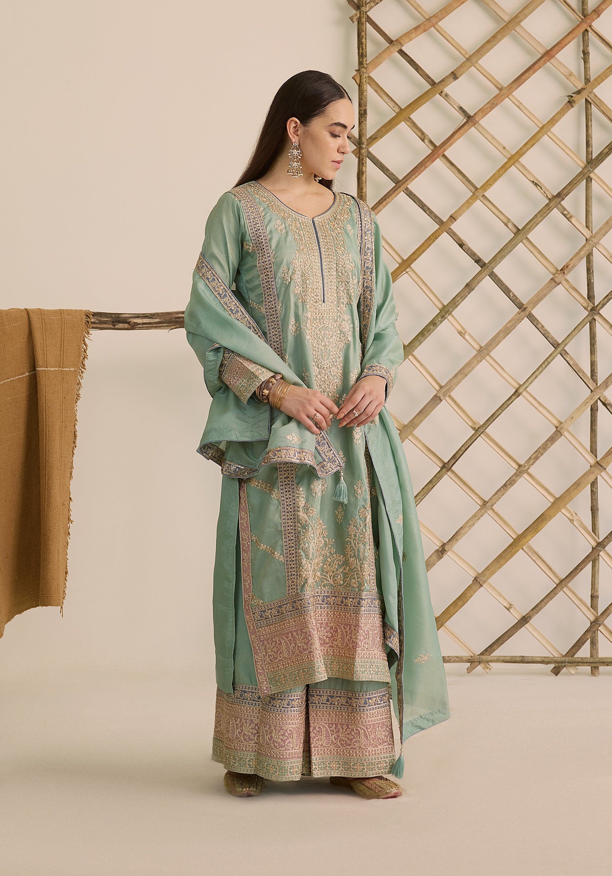 Mint green Vaidehi suit Indian ethnic wear: premium silk with gold floral zardozi embroidery, ornate printed palazzo, graceful dupatta, buy salwar kameez online with intricate gotta details.