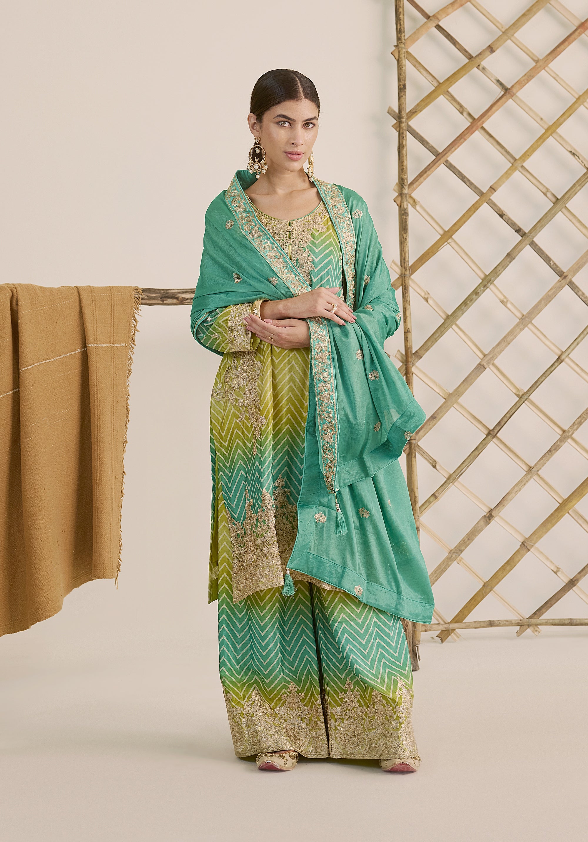 Bright turquoise and sea green Taru suit Indian ethnic wear: premium chiffon silk with gold floral embroidery, gradient leheriya palazzo gold borders, tassel dupatta, buy salwar kameez online Gujarat style.