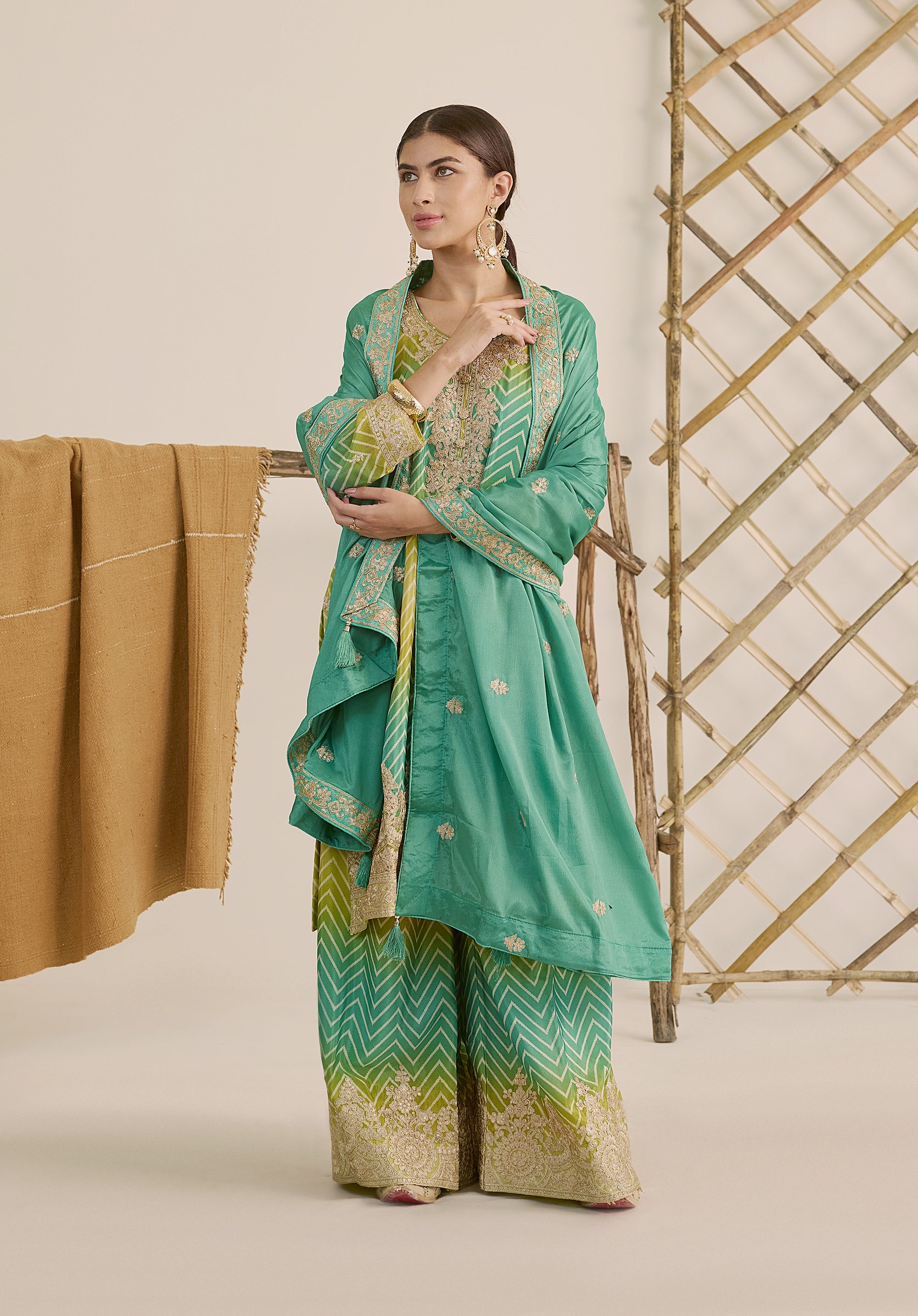 Bright turquoise and sea green Taru suit Indian ethnic wear: premium chiffon silk with gold floral embroidery, gradient leheriya palazzo gold borders, tassel dupatta, buy salwar kameez online Gujarat style.
