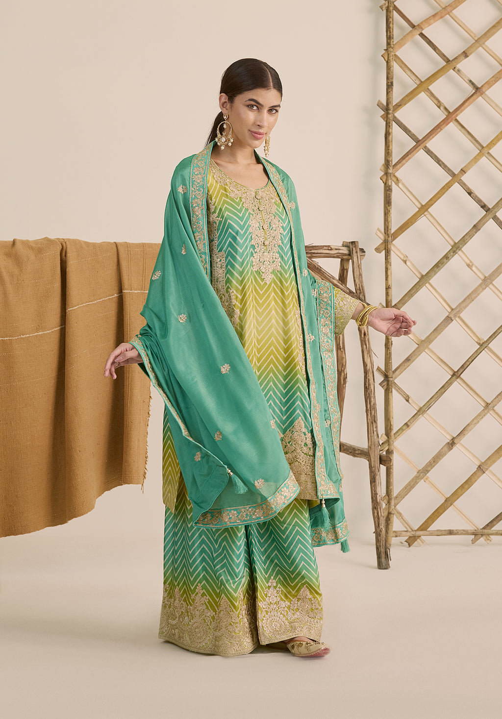 Bright turquoise and sea green Taru suit Indian ethnic wear: premium chiffon silk with gold floral embroidery, gradient leheriya palazzo gold borders, tassel dupatta, buy salwar kameez online Gujarat style.