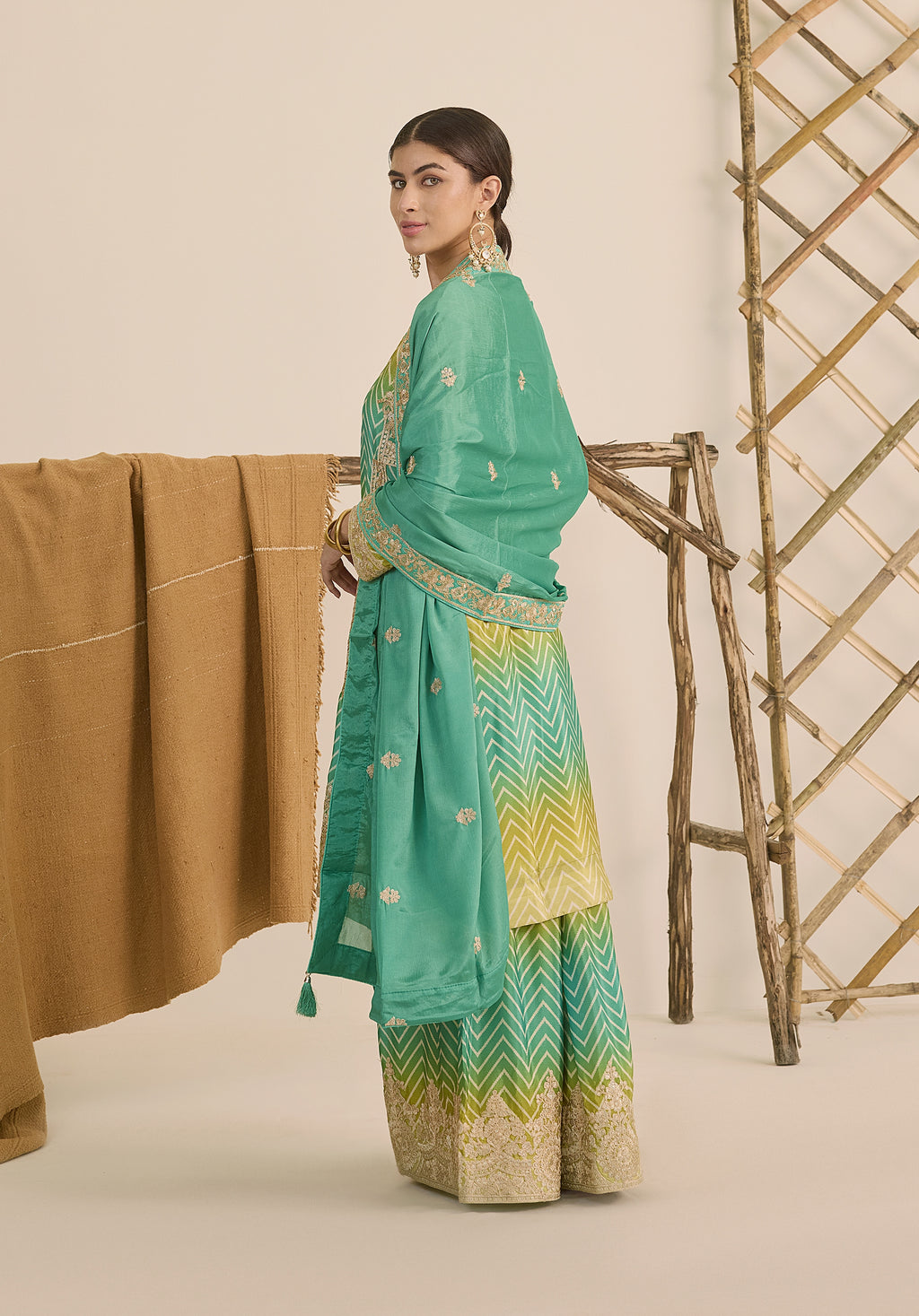 Bright turquoise and sea green Taru suit Indian ethnic wear: premium chiffon silk with gold floral embroidery, gradient leheriya palazzo gold borders, tassel dupatta, buy salwar kameez online Gujarat style.