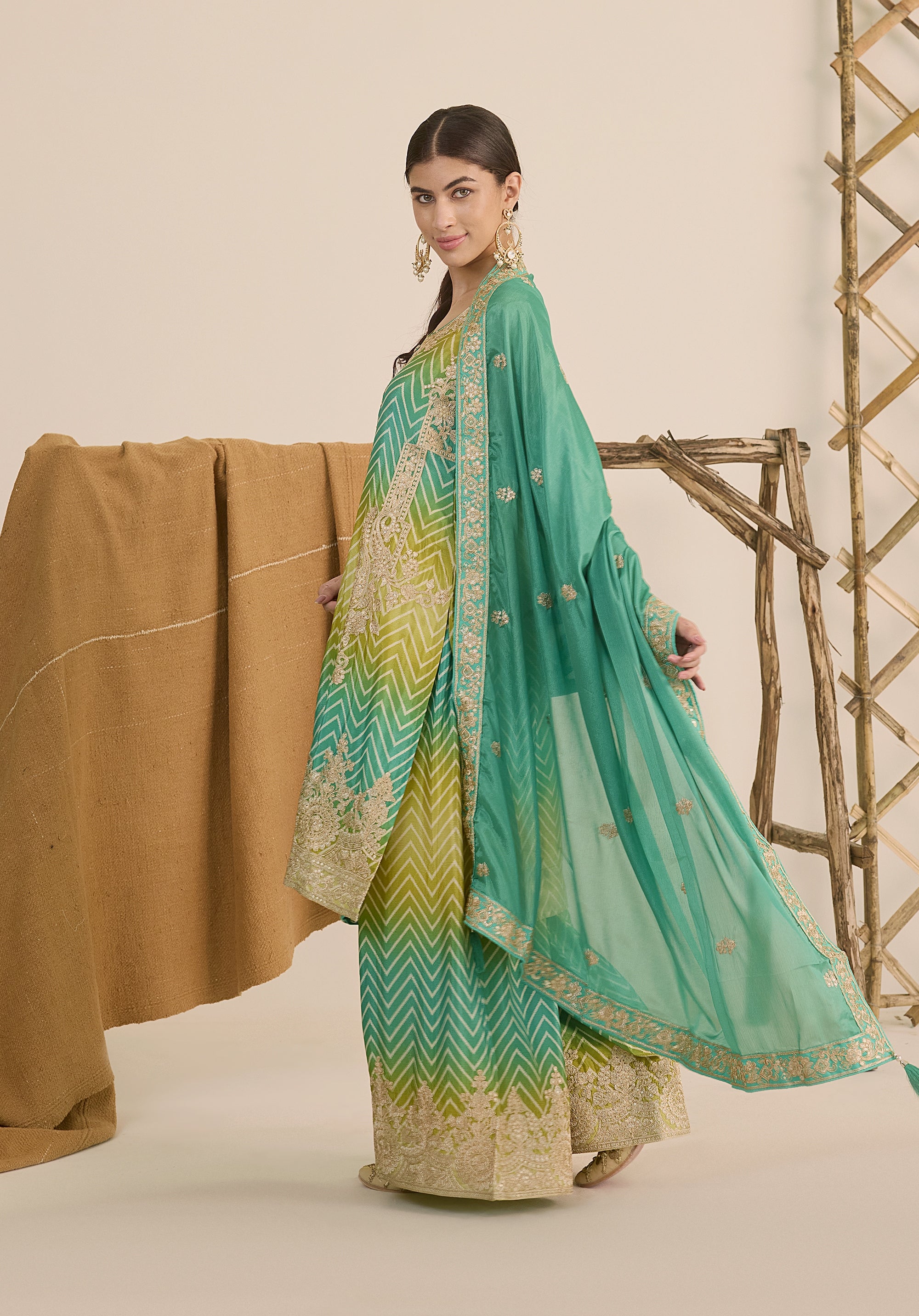 Bright turquoise and sea green Taru suit Indian ethnic wear: premium chiffon silk with gold floral embroidery, gradient leheriya palazzo gold borders, tassel dupatta, buy salwar kameez online Gujarat style.