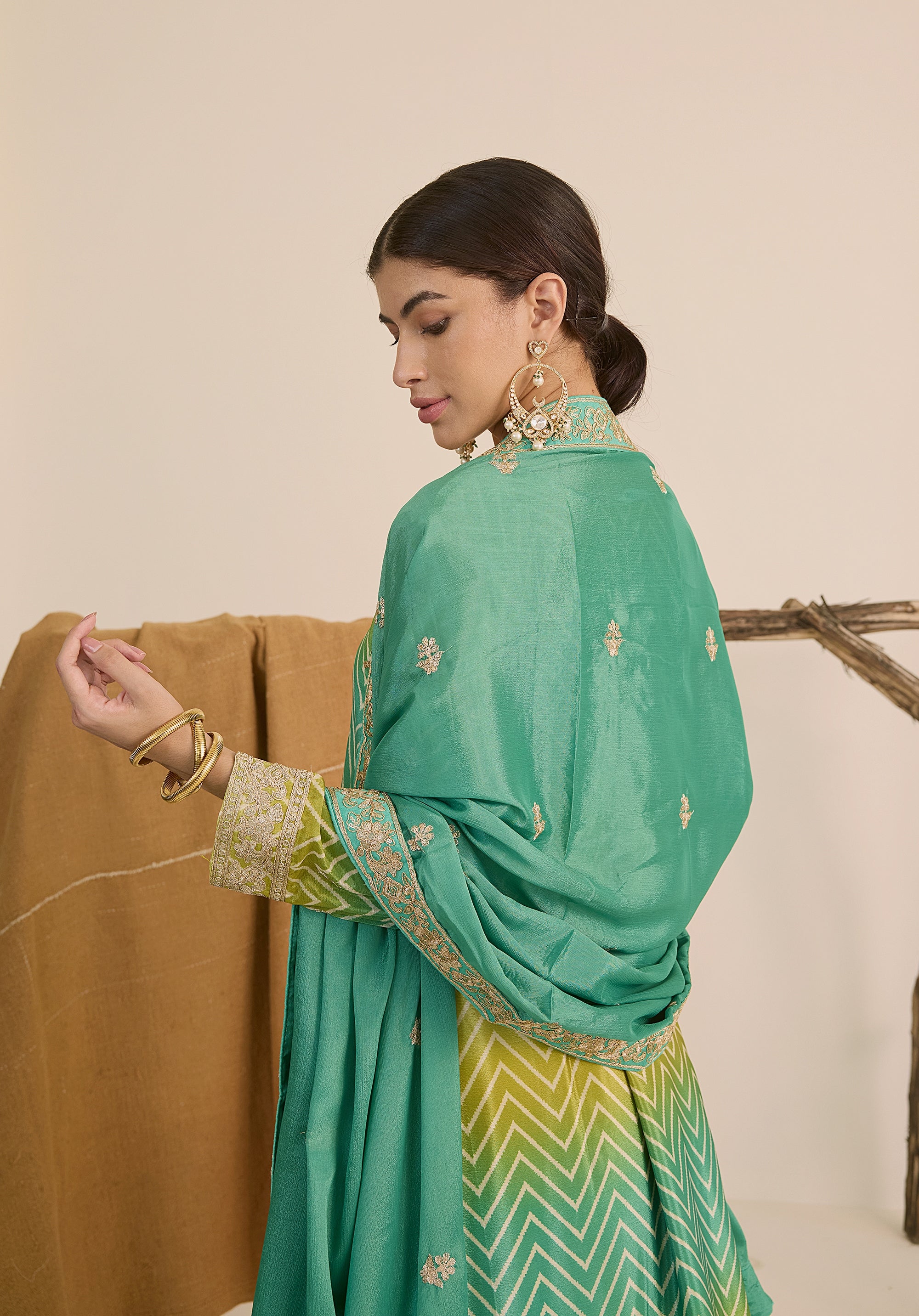 Bright turquoise and sea green Taru suit Indian ethnic wear: premium chiffon silk with gold floral embroidery, gradient leheriya palazzo gold borders, tassel dupatta, buy salwar kameez online Gujarat style.