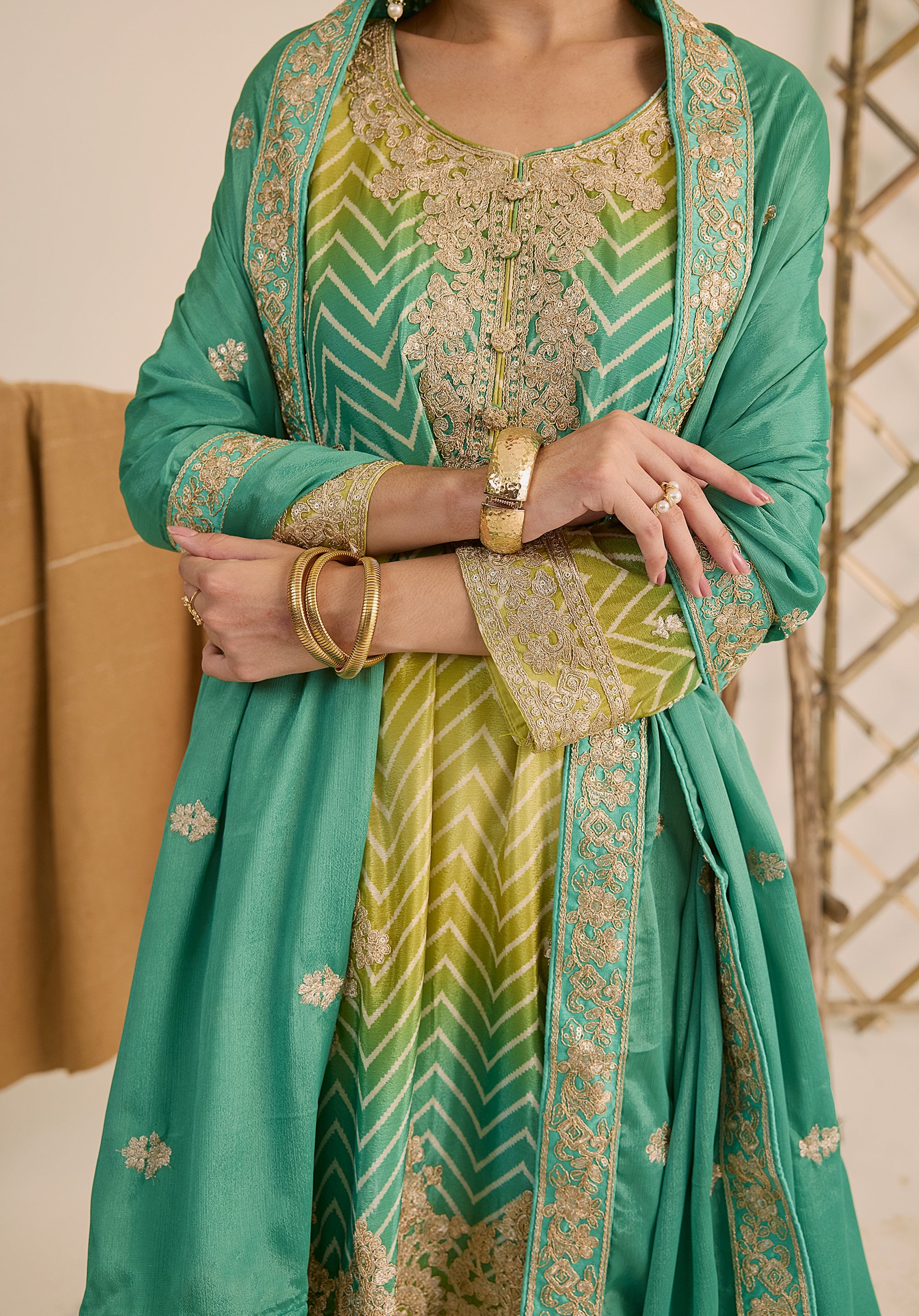 Bright turquoise and sea green Taru suit Indian ethnic wear: premium chiffon silk with gold floral embroidery, gradient leheriya palazzo gold borders, tassel dupatta, buy salwar kameez online Gujarat style.