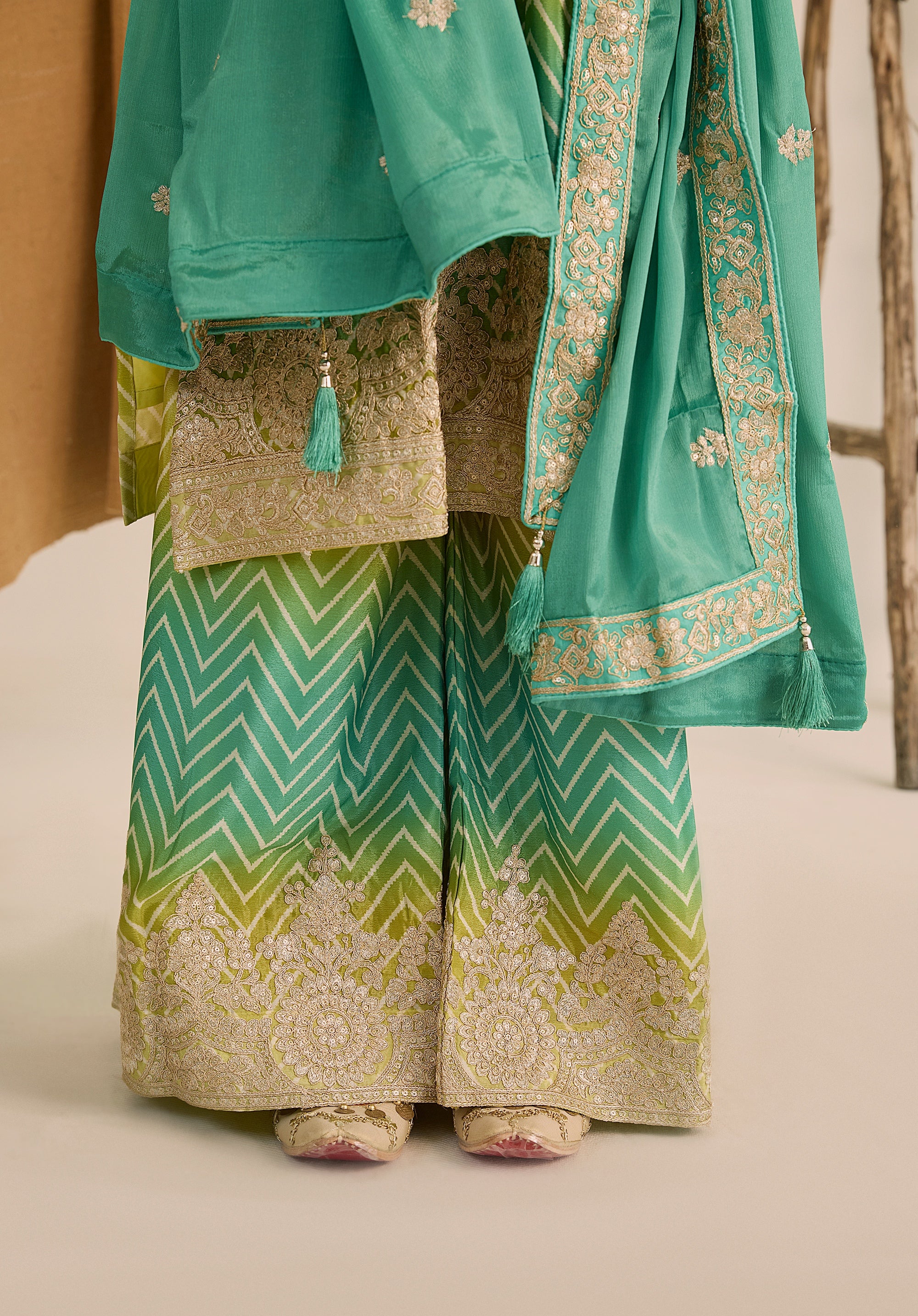 Bright turquoise and sea green Taru suit Indian ethnic wear: premium chiffon silk with gold floral embroidery, gradient leheriya palazzo gold borders, tassel dupatta, buy salwar kameez online Gujarat style.