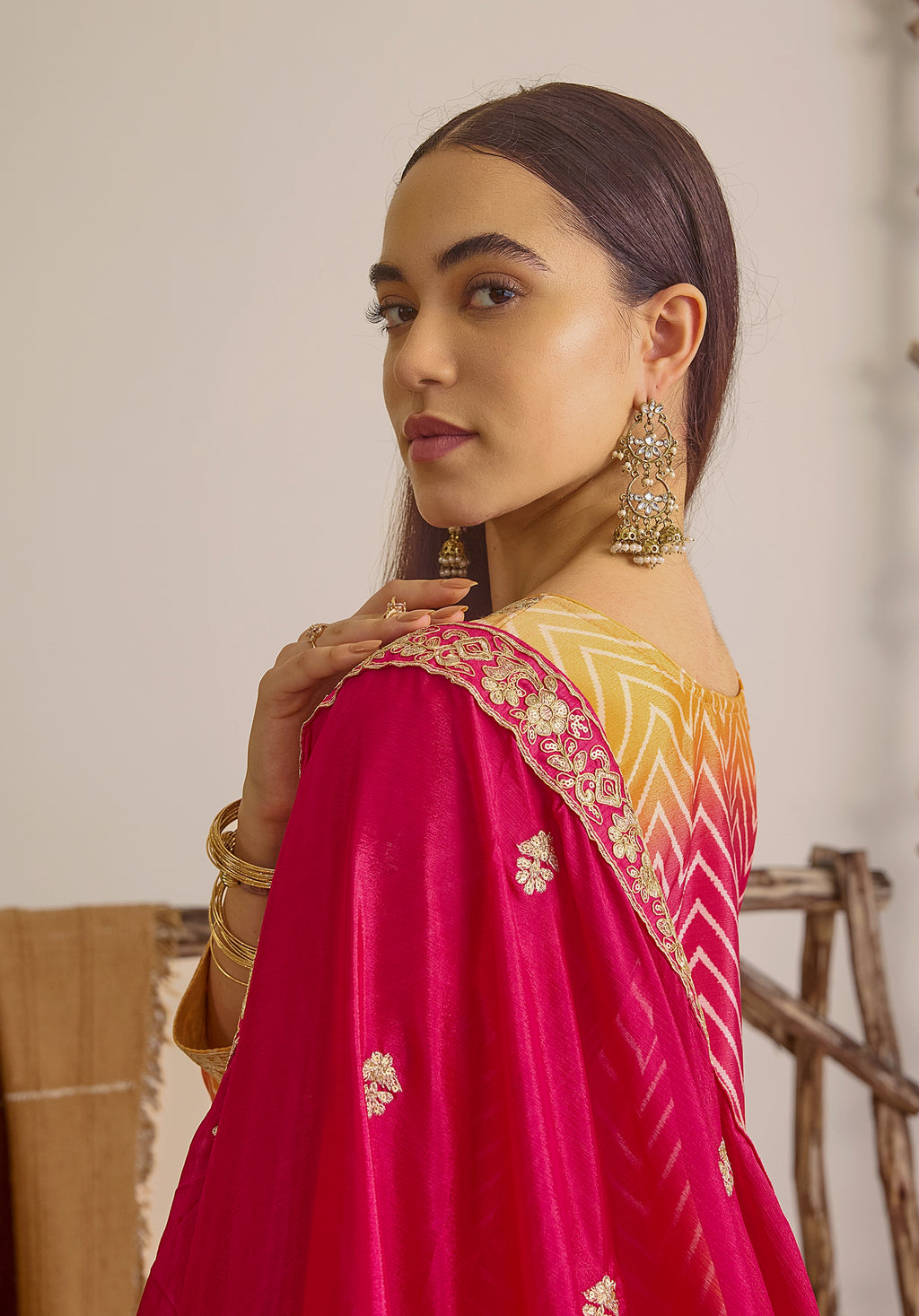 Gradient yellow pink Ira suit Indian ethnic wear: premium chiffon silk with gold floral embroidery, leheriya palazzo gold borders, ethereal tassel dupatta, buy salwar kameez online for festive grace.