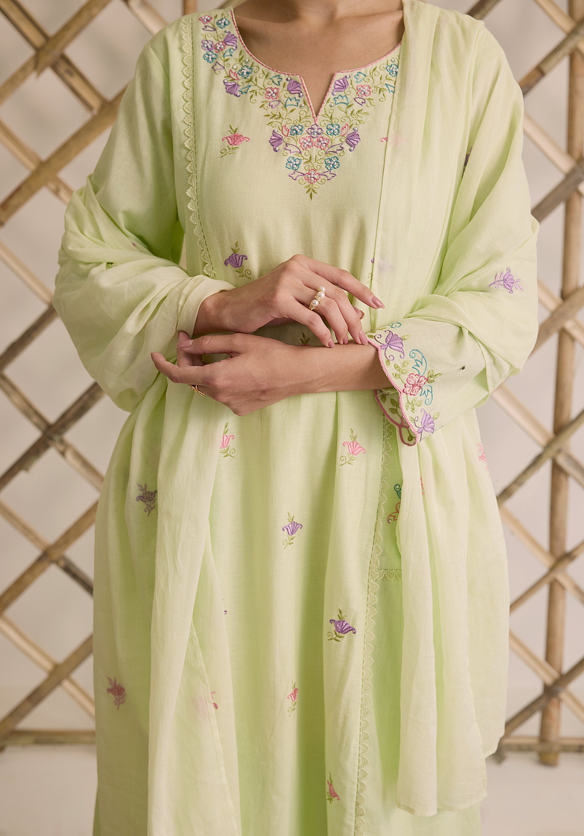 Light sage green Noor Kashmiri suit Indian ethnic wear: premium cotton with multicolored floral motifs, tailored straight pants, star-embroidered dupatta, buy salwar kameez online Kashmir collection.
