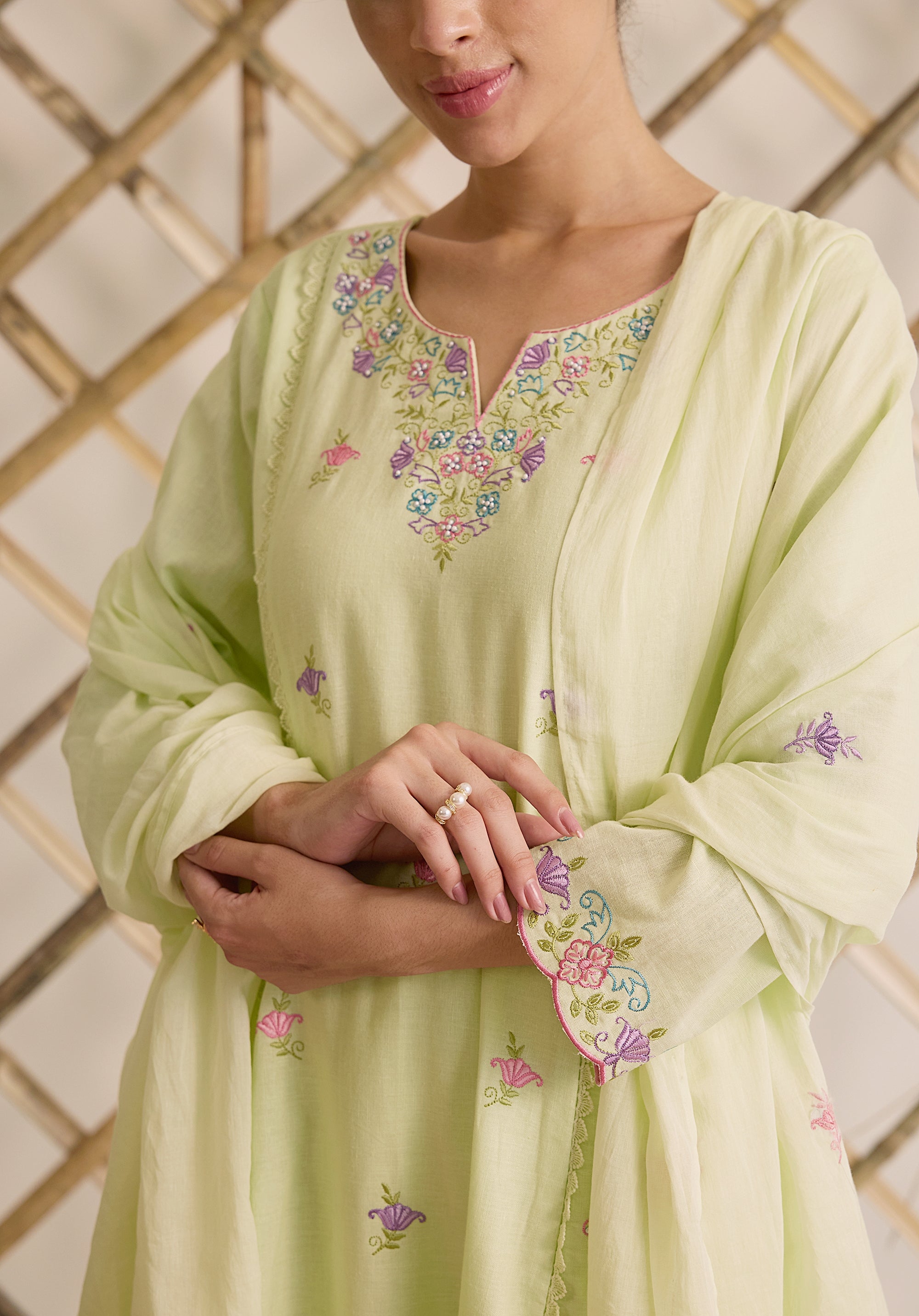 Light sage green Noor Kashmiri suit Indian ethnic wear: premium cotton with multicolored floral motifs, tailored straight pants, star-embroidered dupatta, buy salwar kameez online Kashmir collection.